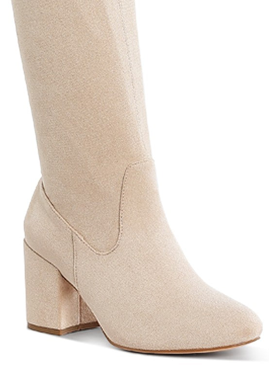 Beige knee-high boot with a block heel on a white background