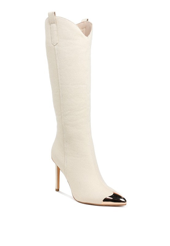 White knee-high boot with black pointed toe on a white background