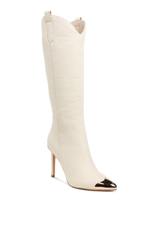 White knee-high boot with black pointed toe on a white background