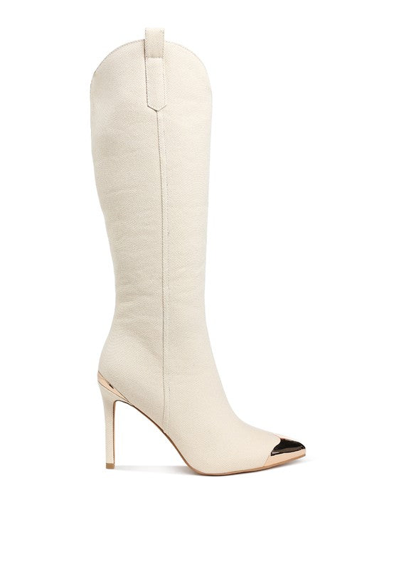 White knee-high boot with a gold cap toe on a white background