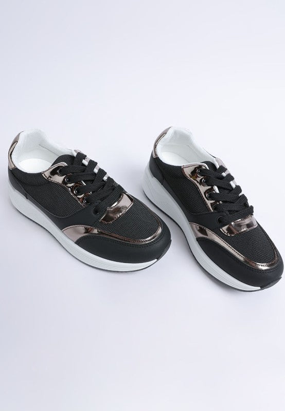 Black sneakers with metallic accents on a white background