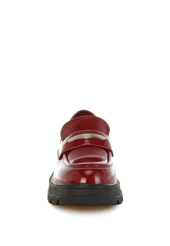 Red shoe with a black sole on a white background