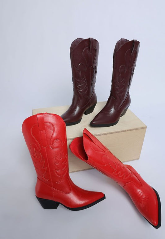 Red and brown cowboy boots on a white background