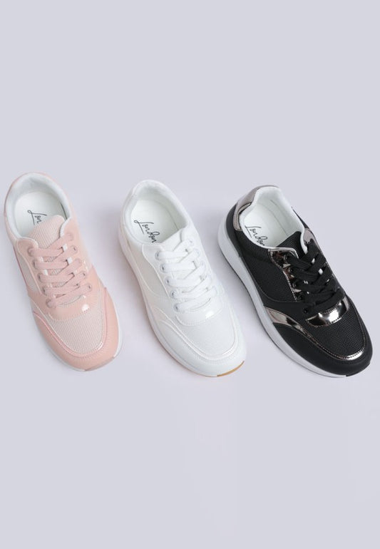 Three sneakers in pink, white, and black on a light gray background