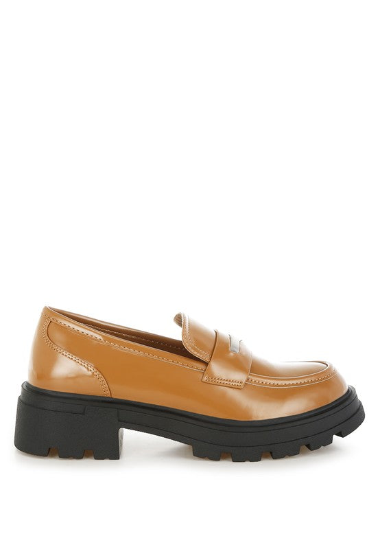 Tan loafer with black sole on a white background