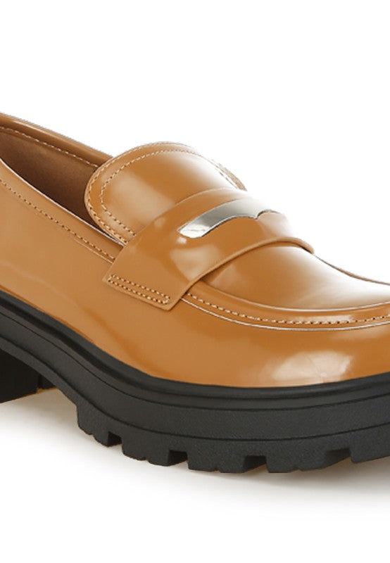 Brown loafers with a black sole on a white background